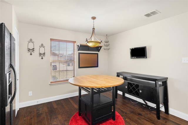 dining area featuring dark hardwood / wood-style flooring