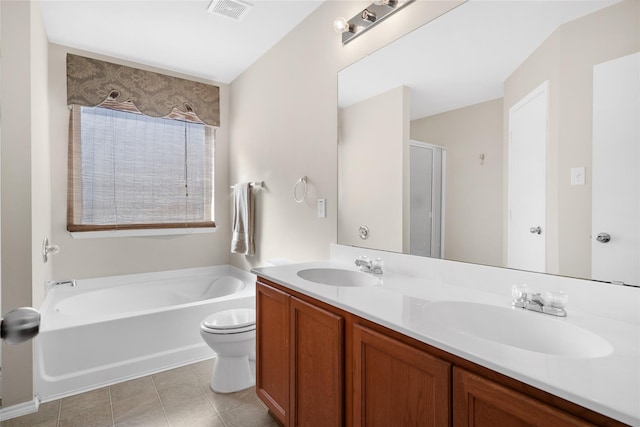 bathroom featuring vanity, a bathtub, and toilet