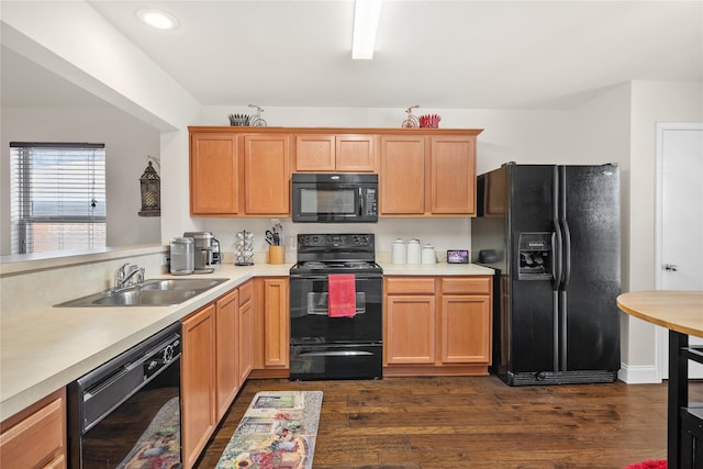 kitchen with sink, dark wood-type flooring, and black appliances