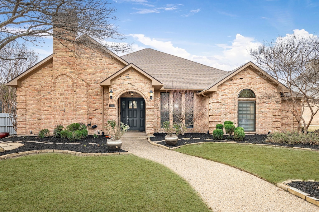 view of front facade featuring a front lawn and french doors