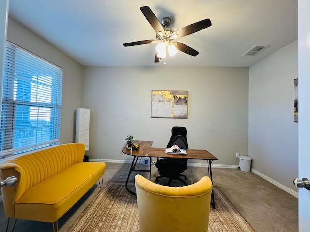 carpeted home office with ceiling fan