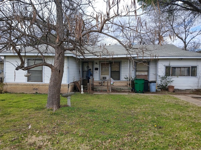 view of front of house with a front yard and cooling unit