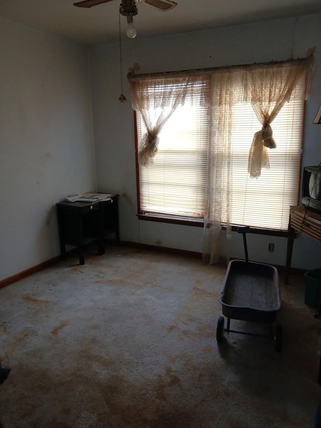 sitting room featuring a healthy amount of sunlight, ceiling fan, and carpet flooring