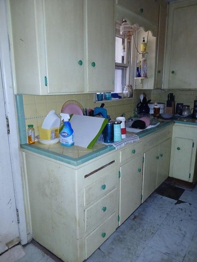 kitchen featuring white cabinets, sink, and backsplash