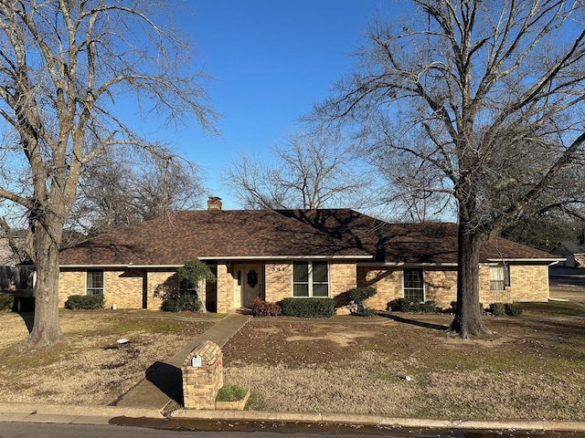 single story home with a front lawn