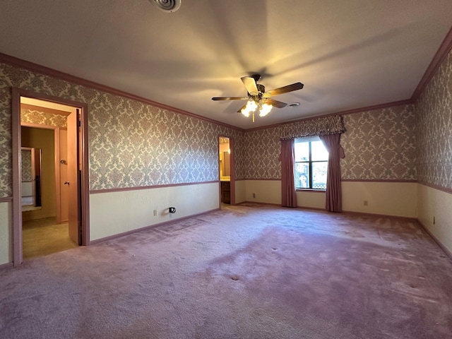 unfurnished room featuring crown molding, carpet flooring, and ceiling fan