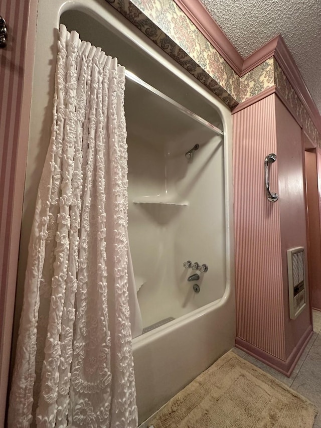 bathroom featuring shower / bath combination with curtain, tile patterned floors, and a textured ceiling