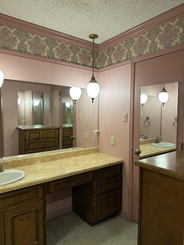 bathroom with crown molding, vanity, and tile patterned floors