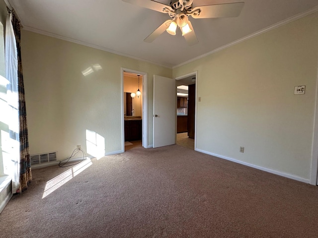 carpeted empty room featuring crown molding and ceiling fan