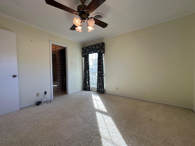 empty room featuring ceiling fan, light colored carpet, and ornamental molding