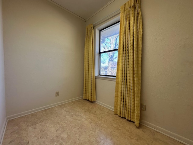 unfurnished room featuring crown molding