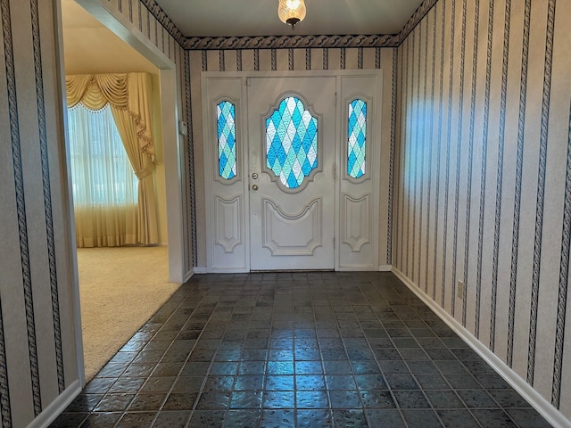 foyer with dark colored carpet