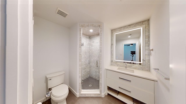 bathroom featuring a shower with shower door, backsplash, tile patterned flooring, vanity, and toilet