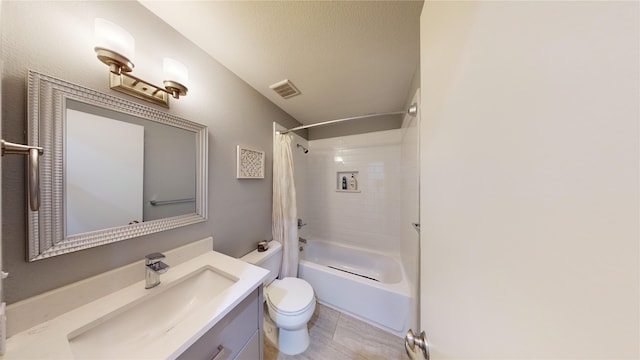 full bathroom featuring shower / bath combo, vanity, a textured ceiling, and toilet