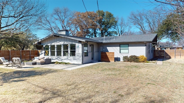 back of property featuring an outdoor living space, a yard, and a patio area