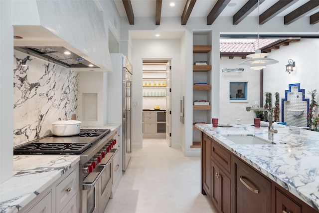 kitchen with sink, light stone counters, ventilation hood, decorative backsplash, and beamed ceiling