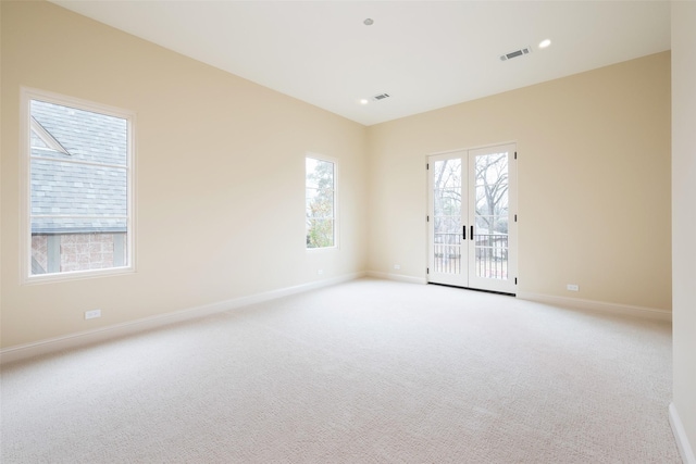 carpeted spare room with french doors