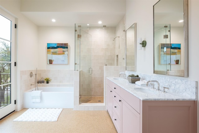 bathroom featuring tile patterned flooring, vanity, shower with separate bathtub, and a healthy amount of sunlight