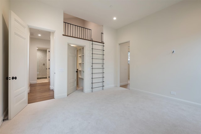 bedroom featuring a spacious closet and light colored carpet