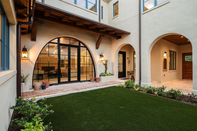 property entrance with a yard and a patio area