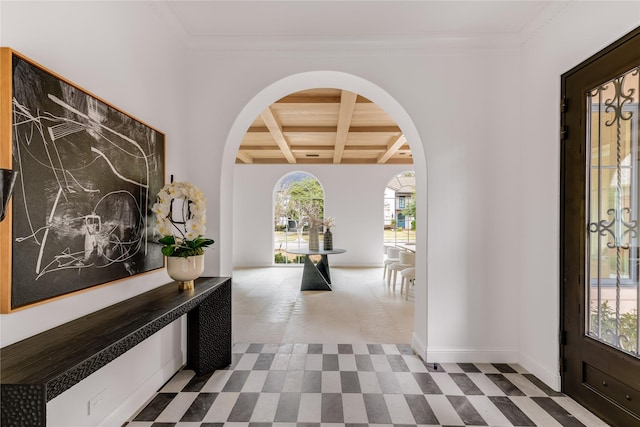 interior space featuring ornamental molding, coffered ceiling, and beam ceiling