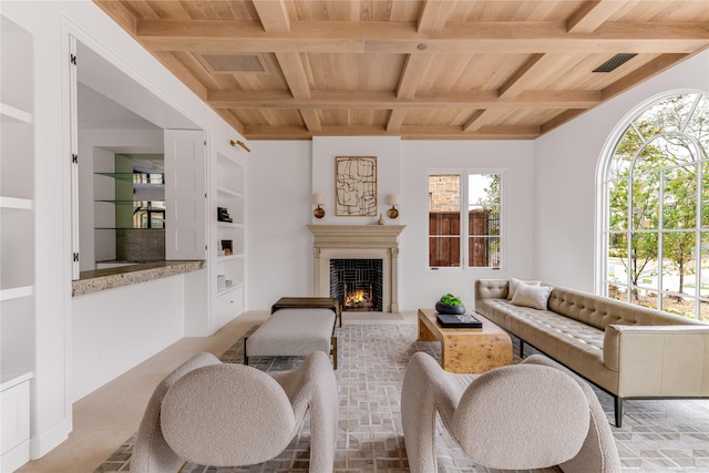 living room with beamed ceiling, wooden ceiling, and built in shelves