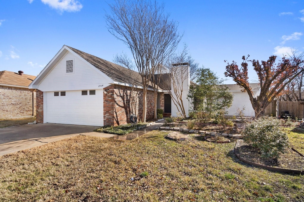 view of front of home featuring a garage and a front lawn