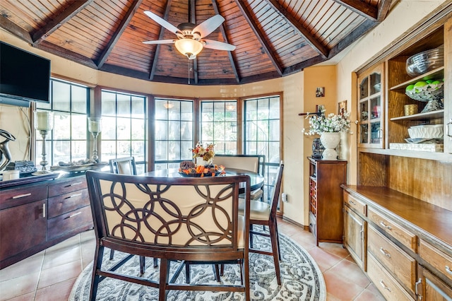 dining area featuring beamed ceiling, light tile patterned floors, wooden ceiling, and ceiling fan