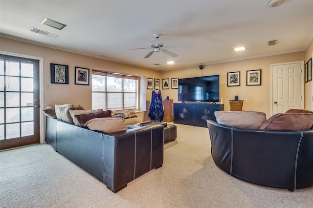 carpeted living room featuring ornamental molding and ceiling fan