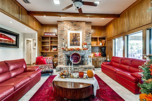 living room with a fireplace, wooden walls, ceiling fan, beam ceiling, and built in shelves