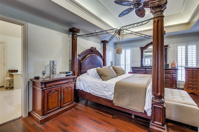 bedroom with dark hardwood / wood-style flooring, ornamental molding, and ceiling fan