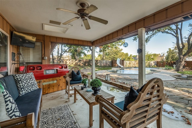 sunroom featuring ceiling fan