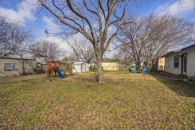 view of yard featuring a storage shed and a playground