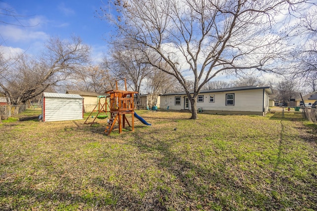 view of yard featuring a storage shed and a playground