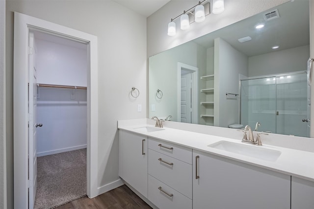 3842-3844 Clovis St, Midlothian, TX 76065 - full bath with wood finished floors, a shower stall, double vanity, a walk in closet, and baseboards