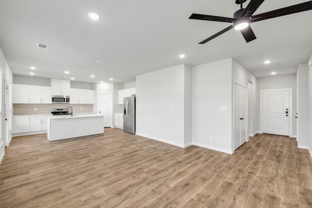 3842-3844 Clovis St, Midlothian, TX 76065 - unfurnished living room featuring light wood finished floors, recessed lighting, ceiling fan, baseboards, and a sink