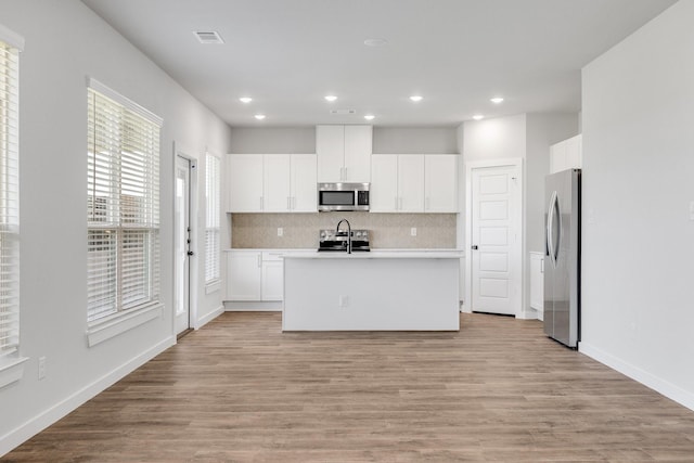 3842-3844 Clovis St, Midlothian, TX 76065 - kitchen featuring stainless steel appliances, backsplash, a kitchen island with sink, recessed lighting, and white cabinets