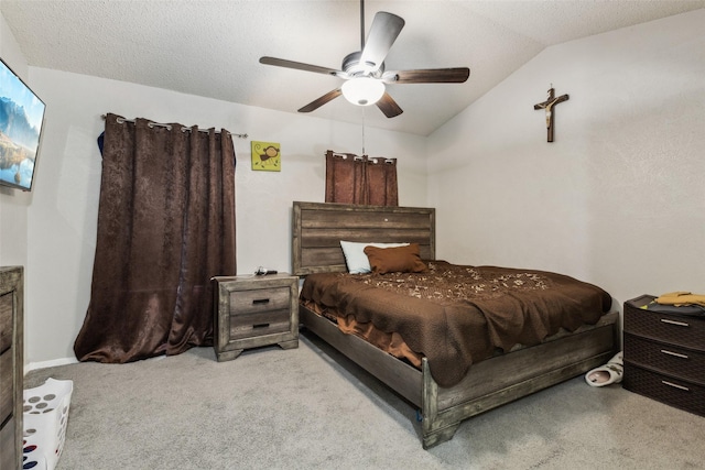 bedroom featuring vaulted ceiling, light colored carpet, a textured ceiling, and ceiling fan