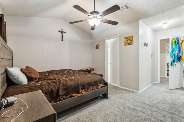 bedroom with light carpet, a textured ceiling, lofted ceiling, and ceiling fan