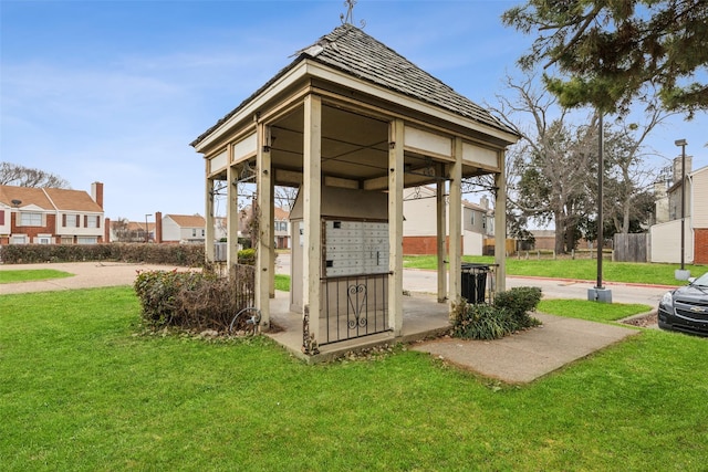 surrounding community featuring a yard and mail boxes