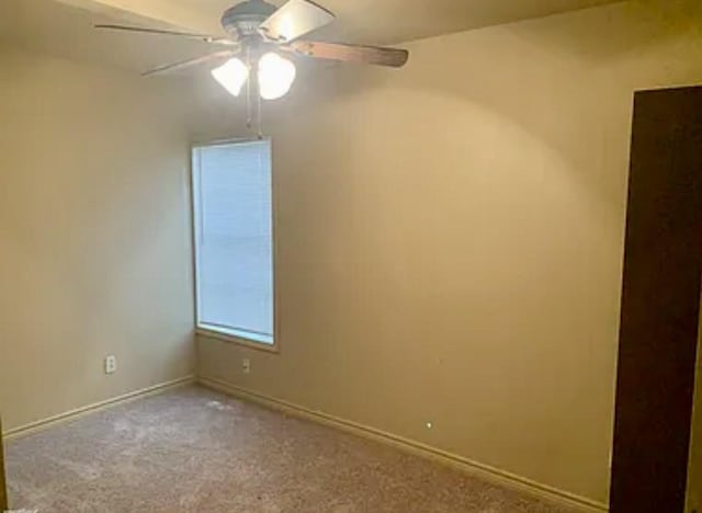 empty room featuring ceiling fan and light carpet