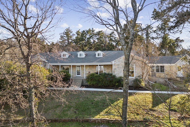 new england style home featuring a front yard