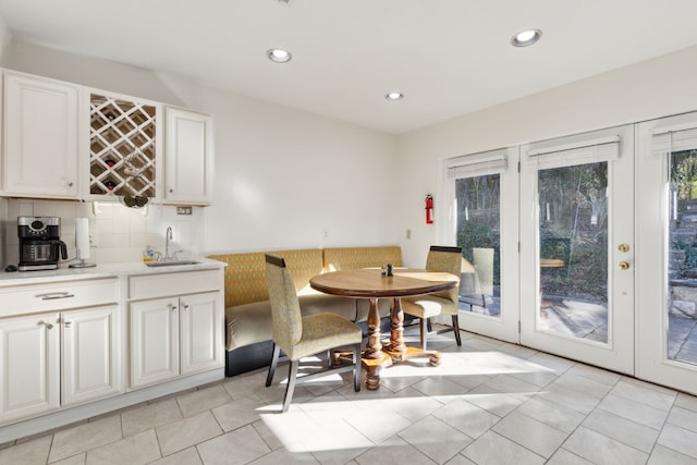 tiled dining space featuring indoor wet bar