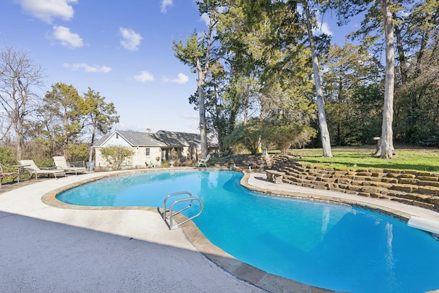 view of swimming pool with a patio area