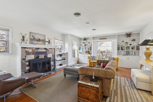 living room with hardwood / wood-style floors and built in shelves