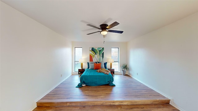 bedroom with ceiling fan and hardwood / wood-style floors