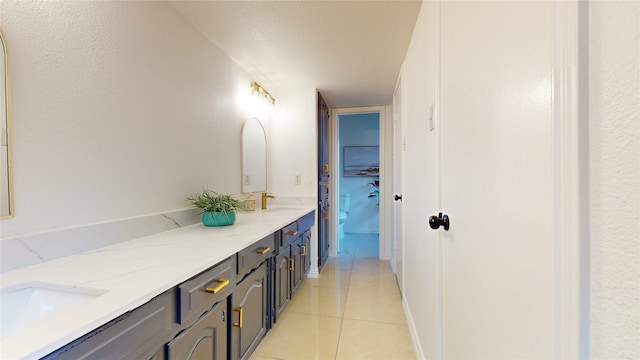 bathroom with tile patterned flooring and vanity