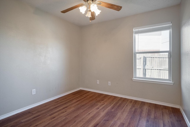 spare room featuring dark hardwood / wood-style flooring and ceiling fan