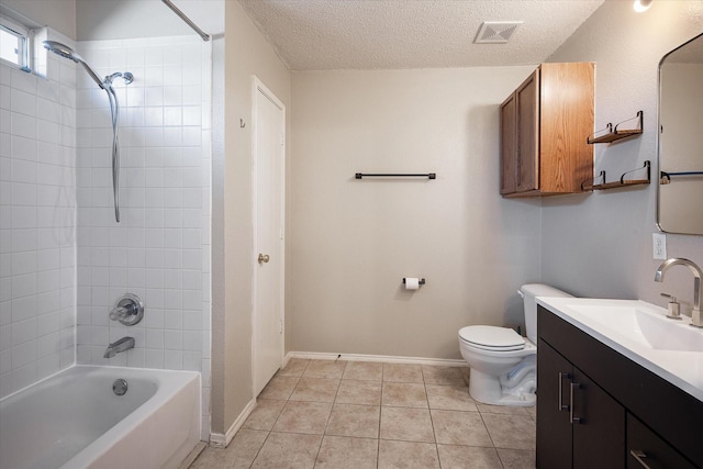 full bathroom featuring tiled shower / bath combo, vanity, toilet, tile patterned floors, and a textured ceiling