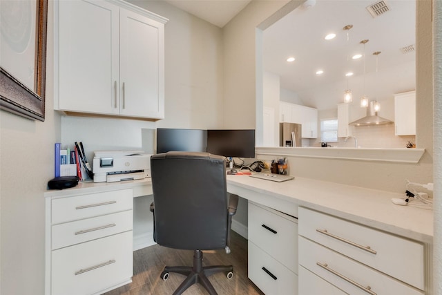 office featuring visible vents, dark wood finished floors, built in study area, vaulted ceiling, and recessed lighting